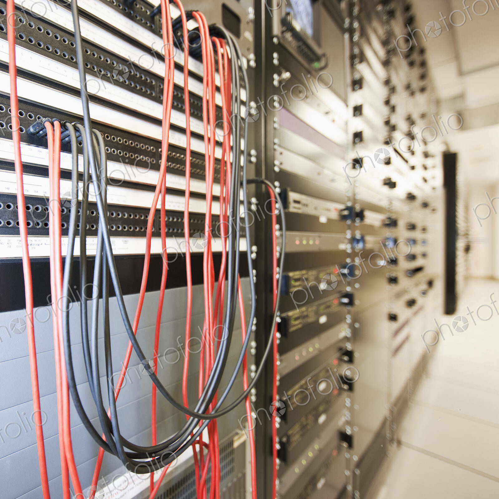 Close up of computer servers and cords in server room