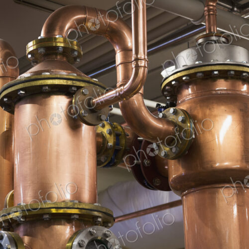 Close up of copper stills in distillery Close up of copper stills in distillery