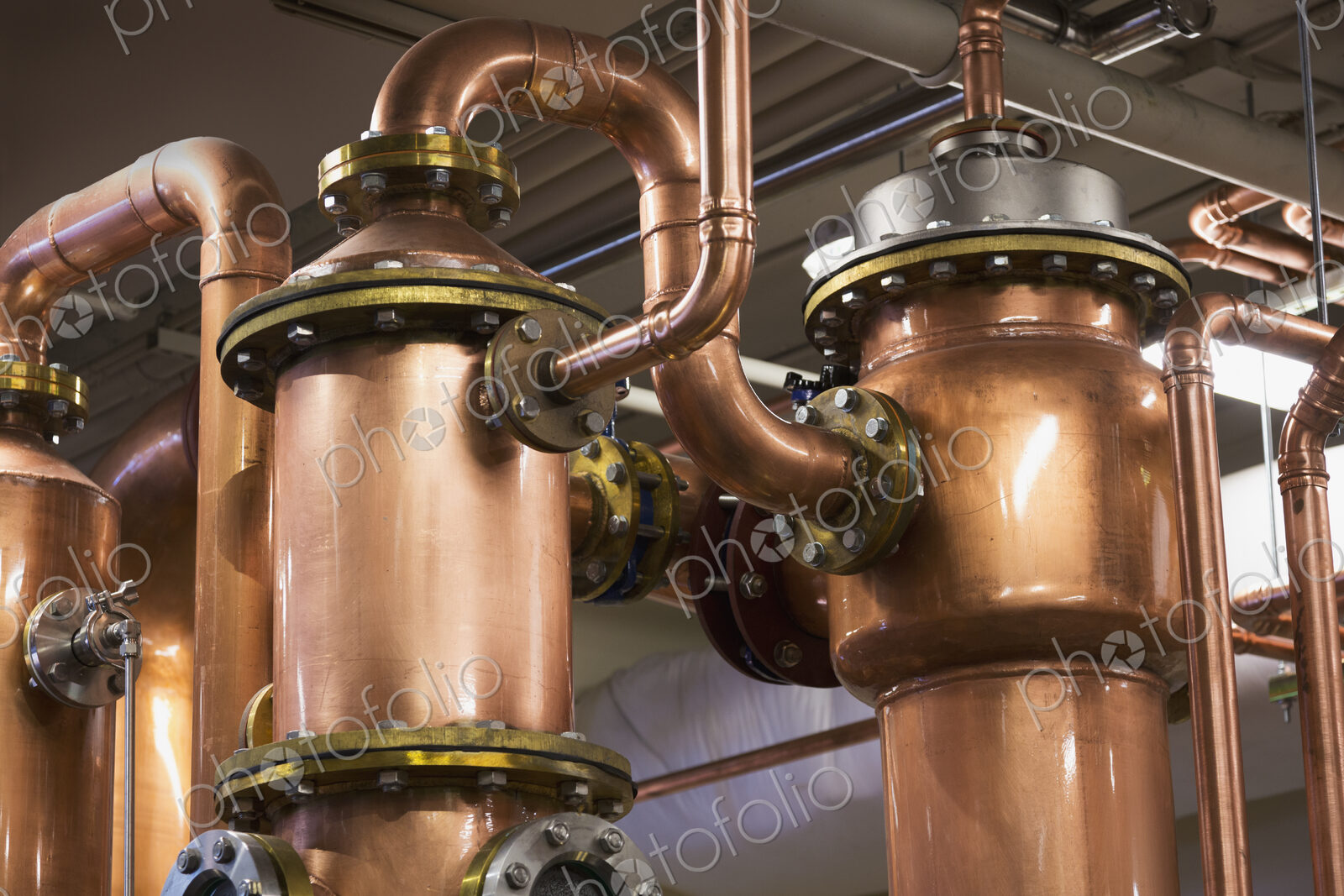 Close up of copper stills in distillery