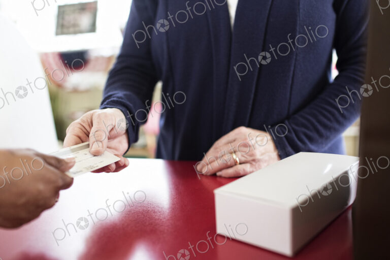 Close up of credit card transaction taking place at a cash register.