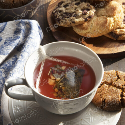Close up of cup of tea with cookie Close up of cup of tea with cookie
