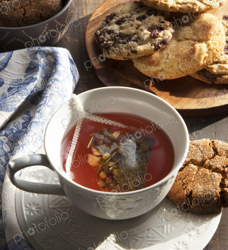 Close up of cup of tea with cookie