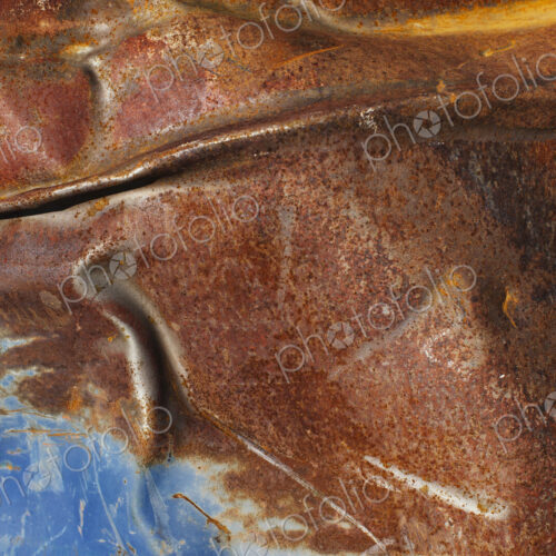Close up of dented and rusty old blue metal oil drum. Close up of dented and rusty old blue metal oil drum.