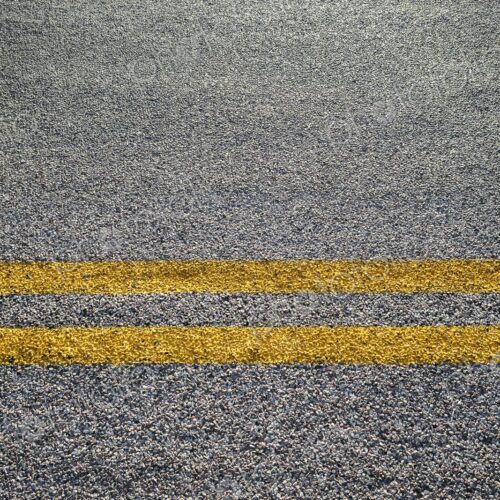 Close-up of double yellow lines painted on an asphalt road, symbolizing rules, safety,… Close-up of double yellow lines painted on an asphalt road, symbolizing rules, safety,…