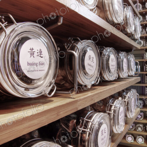 Close up of dried teas in jars on shelves