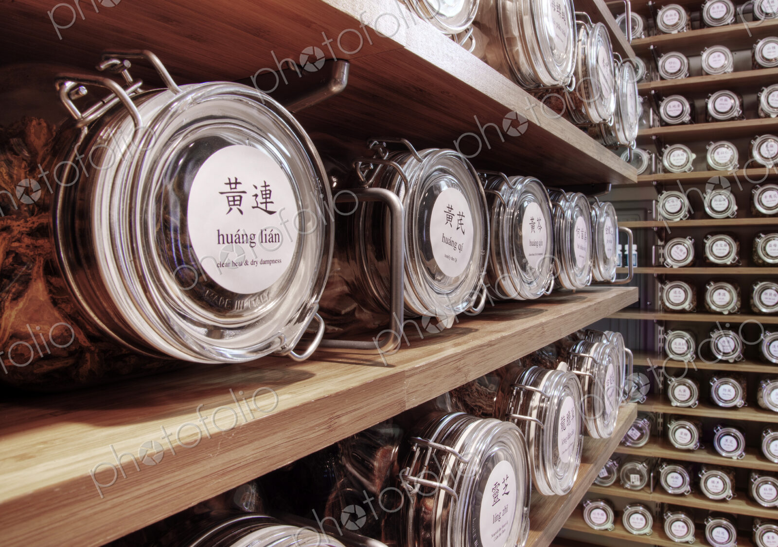 Close up of dried teas in jars on shelves