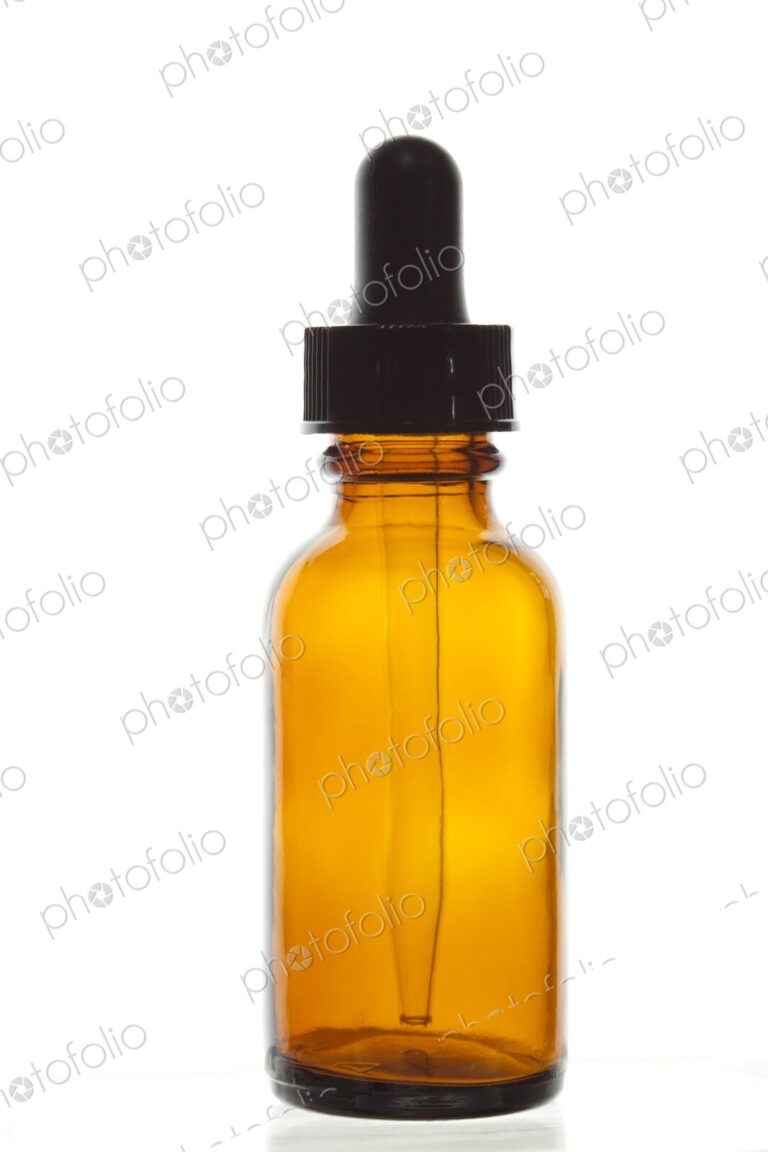 Close-up of dropper bottle, often used to dispense alternative medicine (homeopathy)…