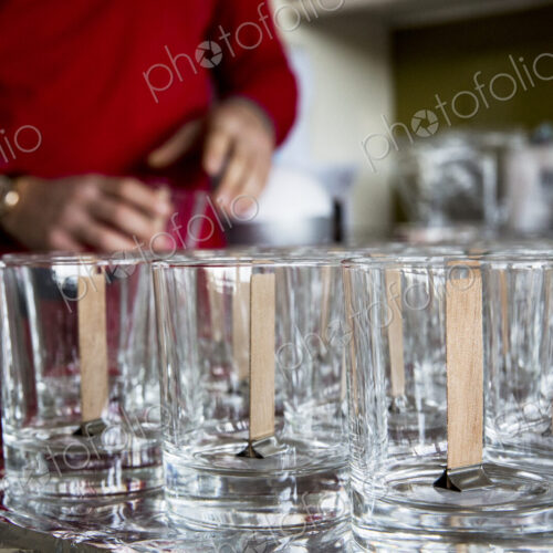 Close up of empty glass jars with wooden wicks, for candle making. Close up of empty glass jars with wooden wicks, for candle making.