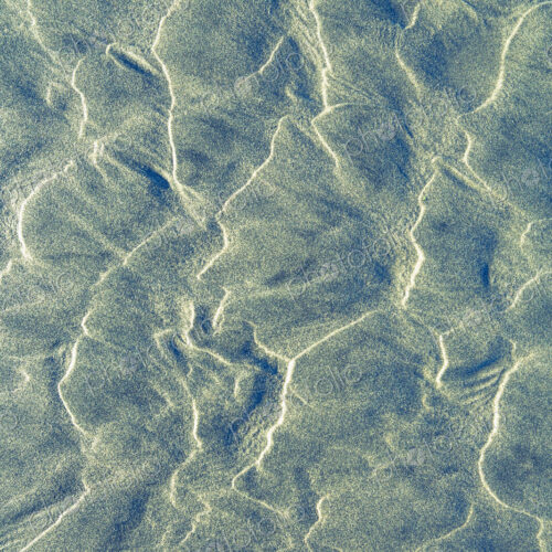 Close up of erosional sand patterns on beach, wavy patterns