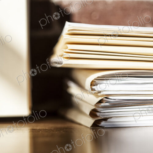 Close-up of files and file folders on a desk top in an office. Close-up of files and file folders on a desk top in an office.