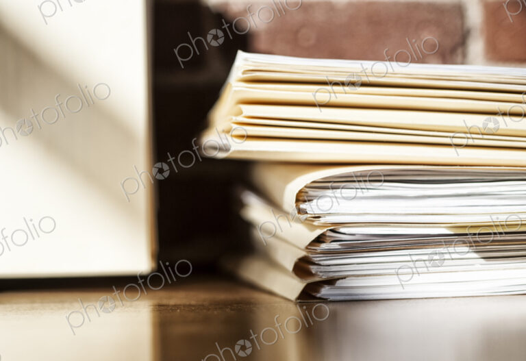 Close-up of files and file folders on a desk top in an office.