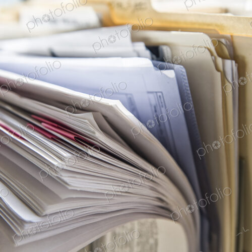 Close-up of files and file folders on a desk top in an office. Close-up of files and file folders on a desk top in an office.