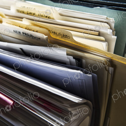 Close-up of files and file folders on a desk top in an office. Close-up of files and file folders on a desk top in an office.