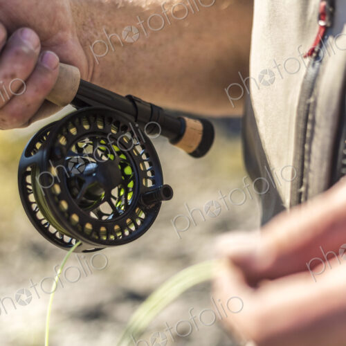 Close up of fisherman holding his fishing rod. Close up of fisherman holding his fishing rod.