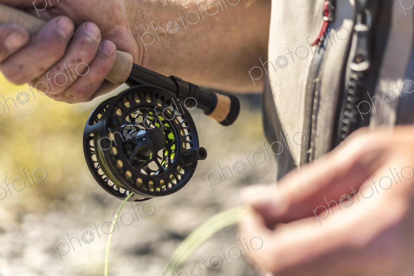 Close up of fisherman holding his fishing rod.