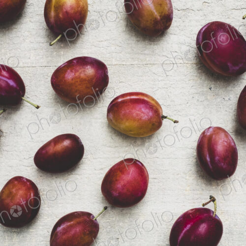 Close up of fresh damsons fruits on grey background. Close up of fresh damsons fruits on grey background.