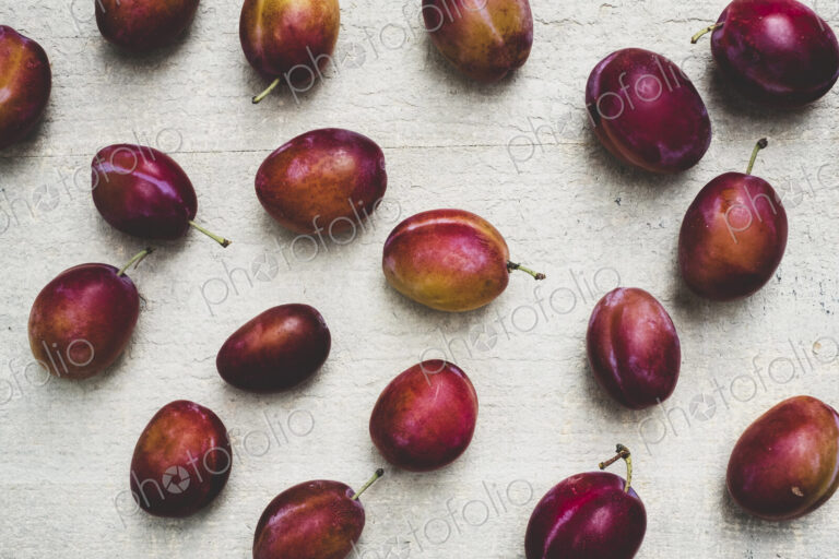 Close up of fresh damsons fruits on grey background.