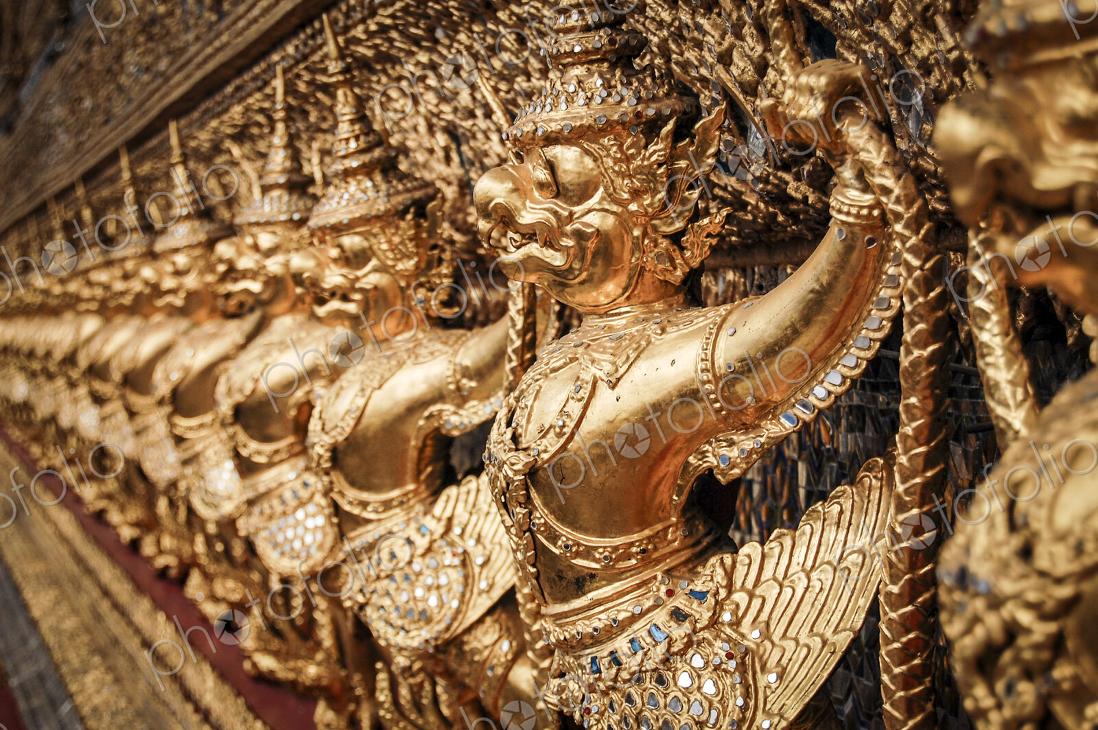 Close up of golden shrine at Wat Pho Buddhist temple complex in Bangkok.