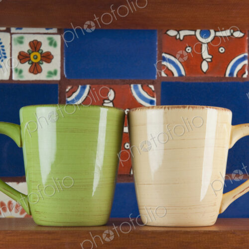 Close up of green and beige mugs