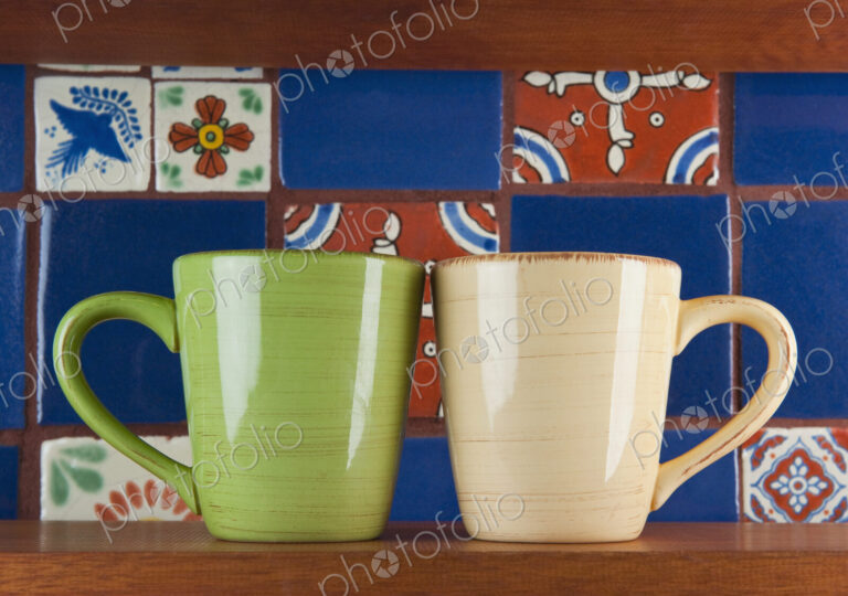 Close up of green and beige mugs
