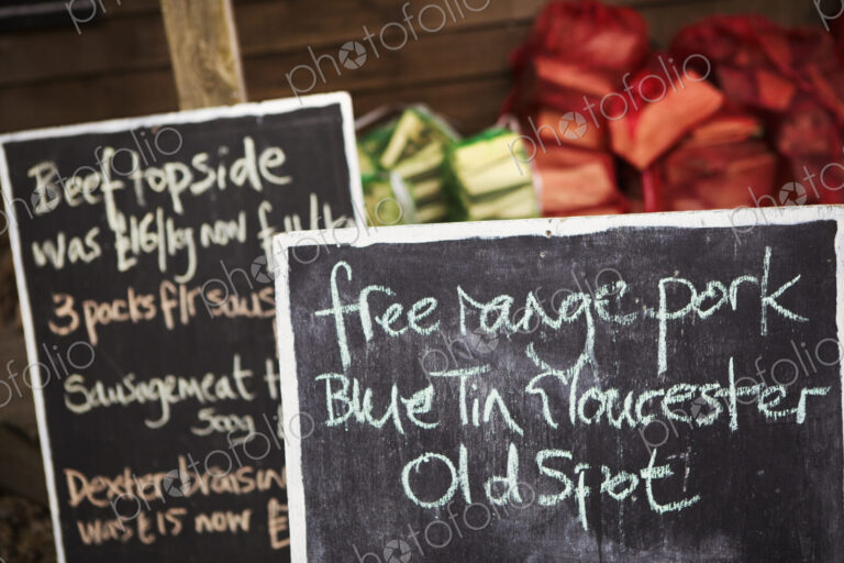 Close up of handwritten blackboard at farm shop advertising free range pork and beef.