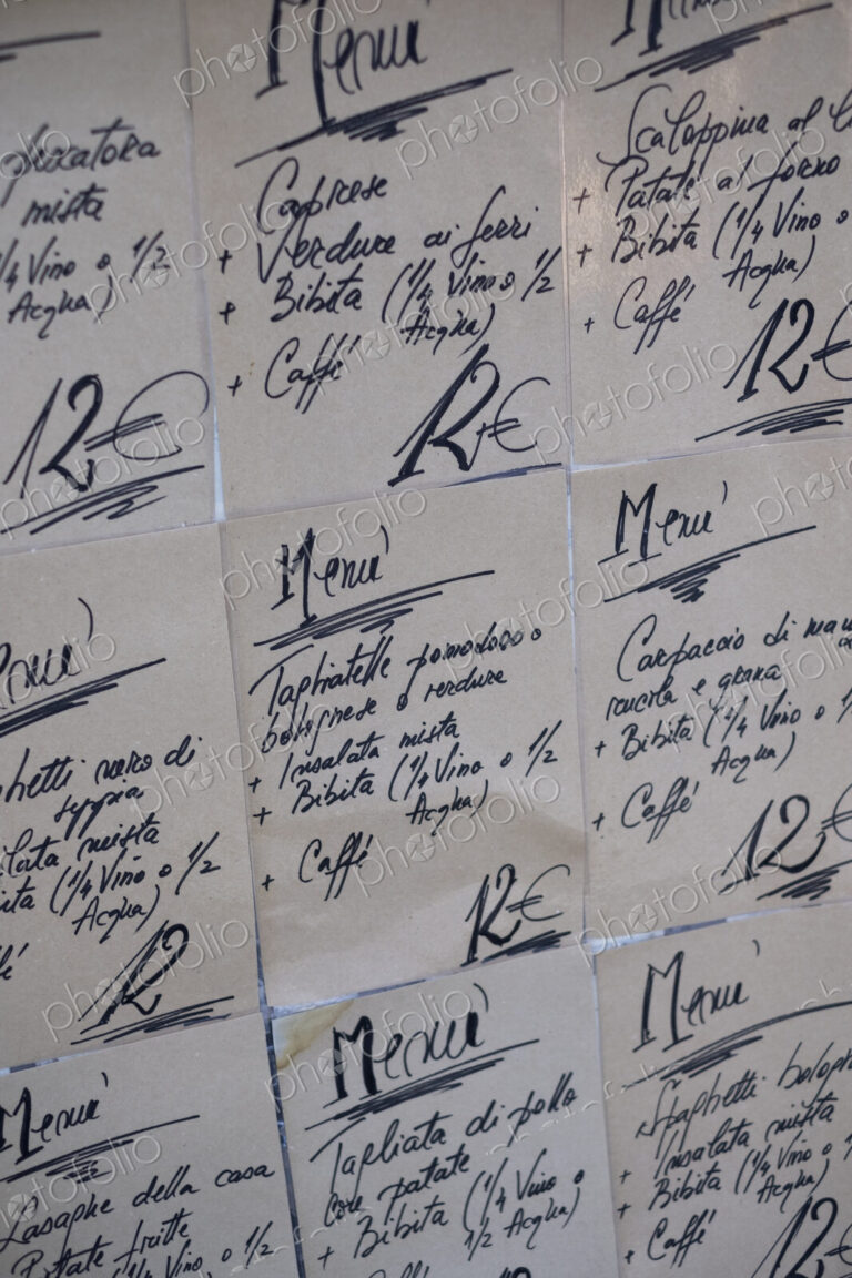 Close up of handwritten set menus on the wall at an Italian restaurant.