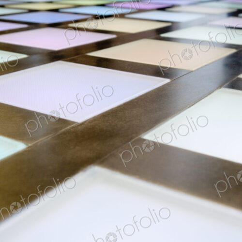 Close-up of illuminated multicoloured tiled dance floor, disco lighting. Close-up of illuminated multicoloured tiled dance floor, disco lighting.