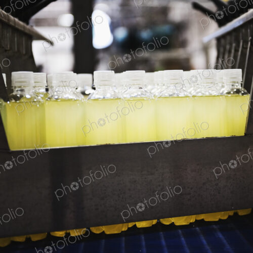Close up of juice in plastic bottles on production line Close up of juice in plastic bottles on production line