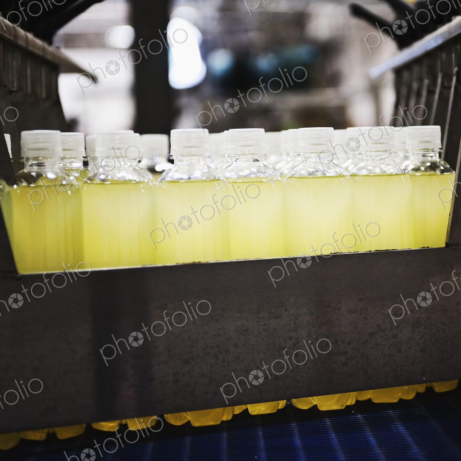 Close up of juice in plastic bottles on production line