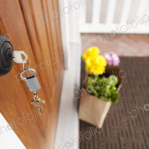 Close up of key in front door lock.