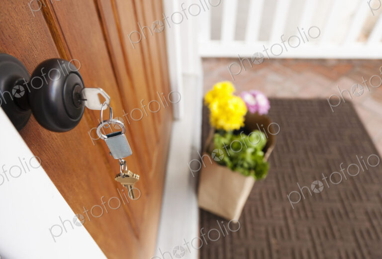 Close up of key in front door lock.