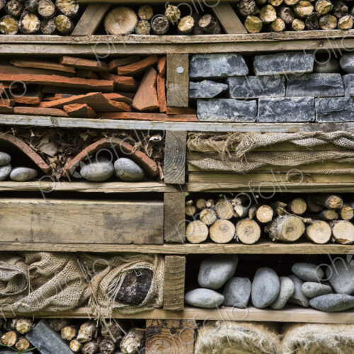 Close up of large bug house with several layers of different materials.