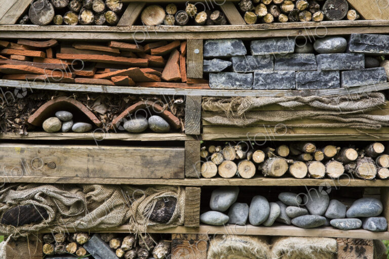Close up of large bug house with several layers of different materials.