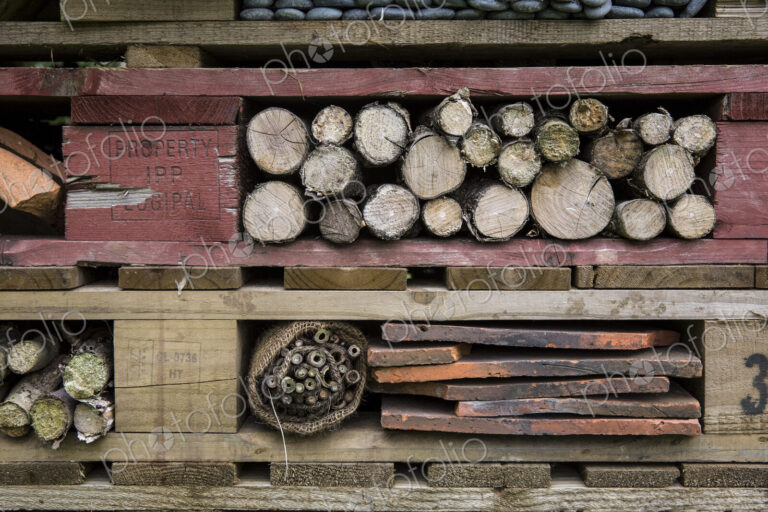 Close up of large bug house with several layers of different materials.