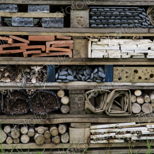 Close up of large bug house with several layers of different materials.
