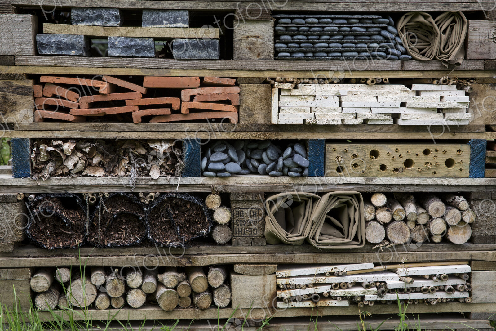 Close up of large bug house with several layers of different materials.