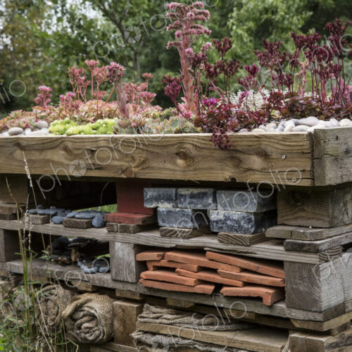 Close up of large bug house with several layers of different materials.