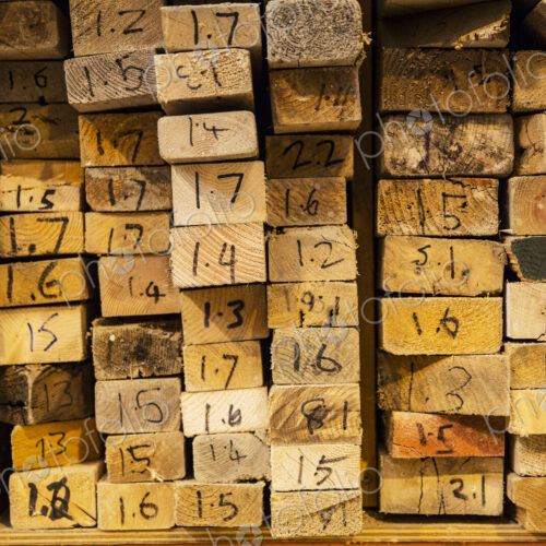 Close up of large selection of wooden planks stacked on shelves in a warehouse. Close up of large selection of wooden planks stacked on shelves in a warehouse.