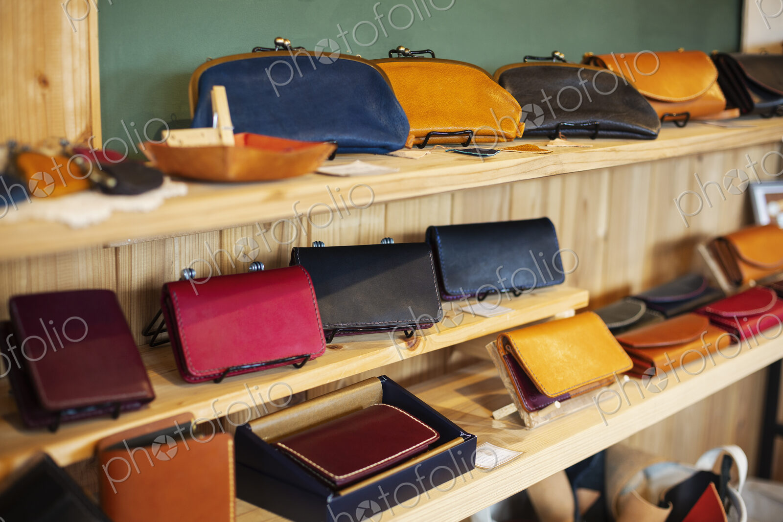 Close up of leather handbags on a shelf in a leather shop.