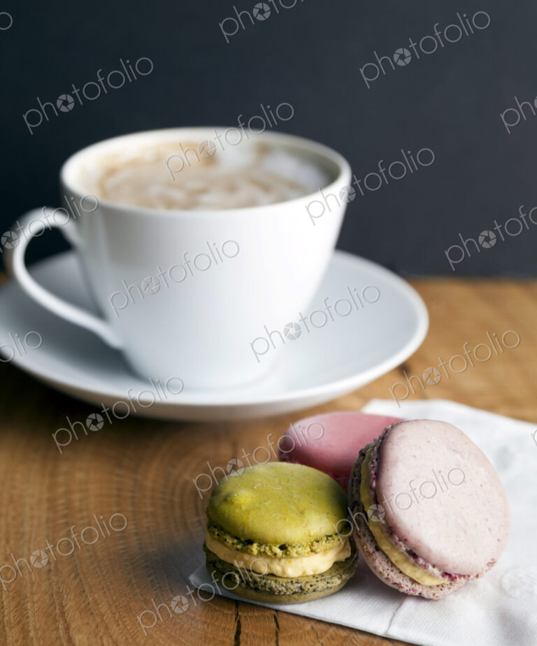 Close up of macaroon cookies and cup of coffee