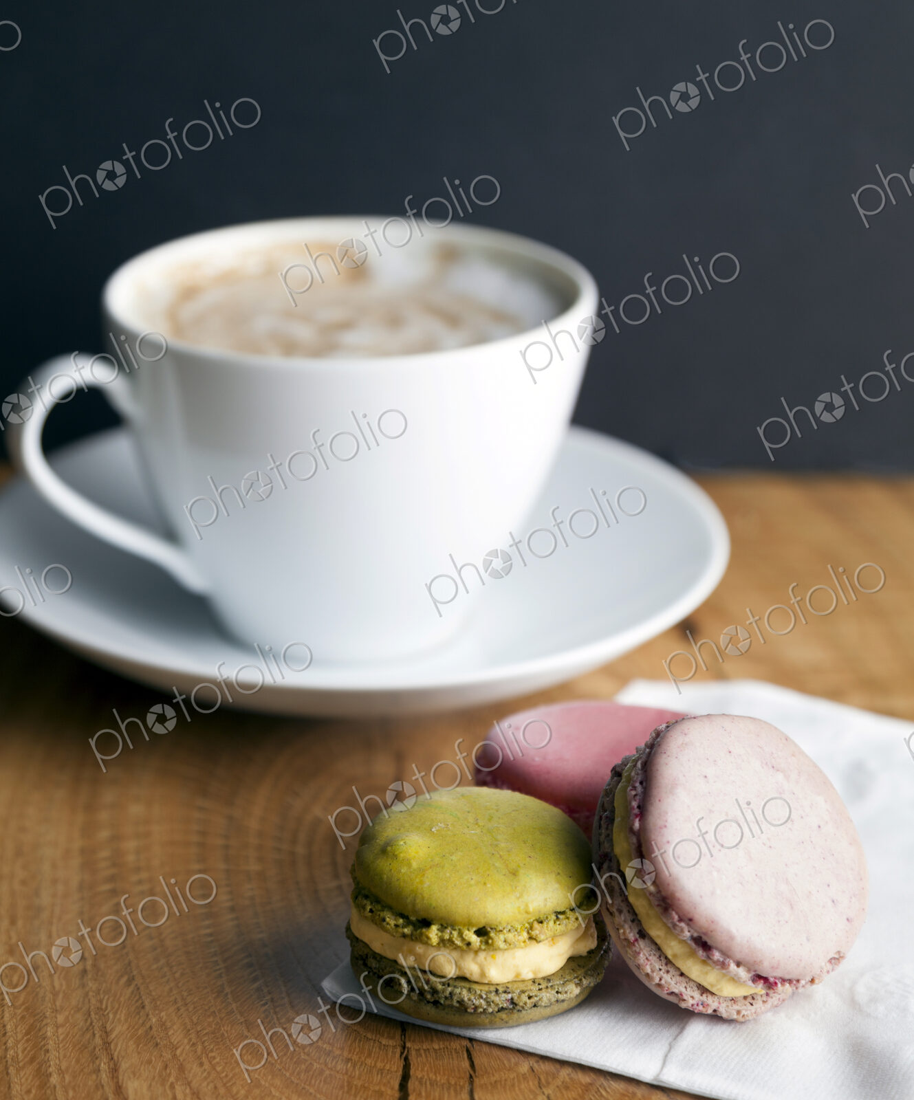 Close up of macaroon cookies and cup of coffee