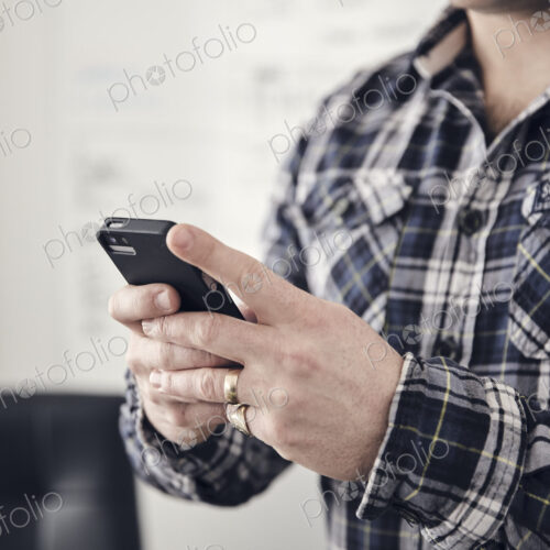 Close up of man's hands using a mobile phone