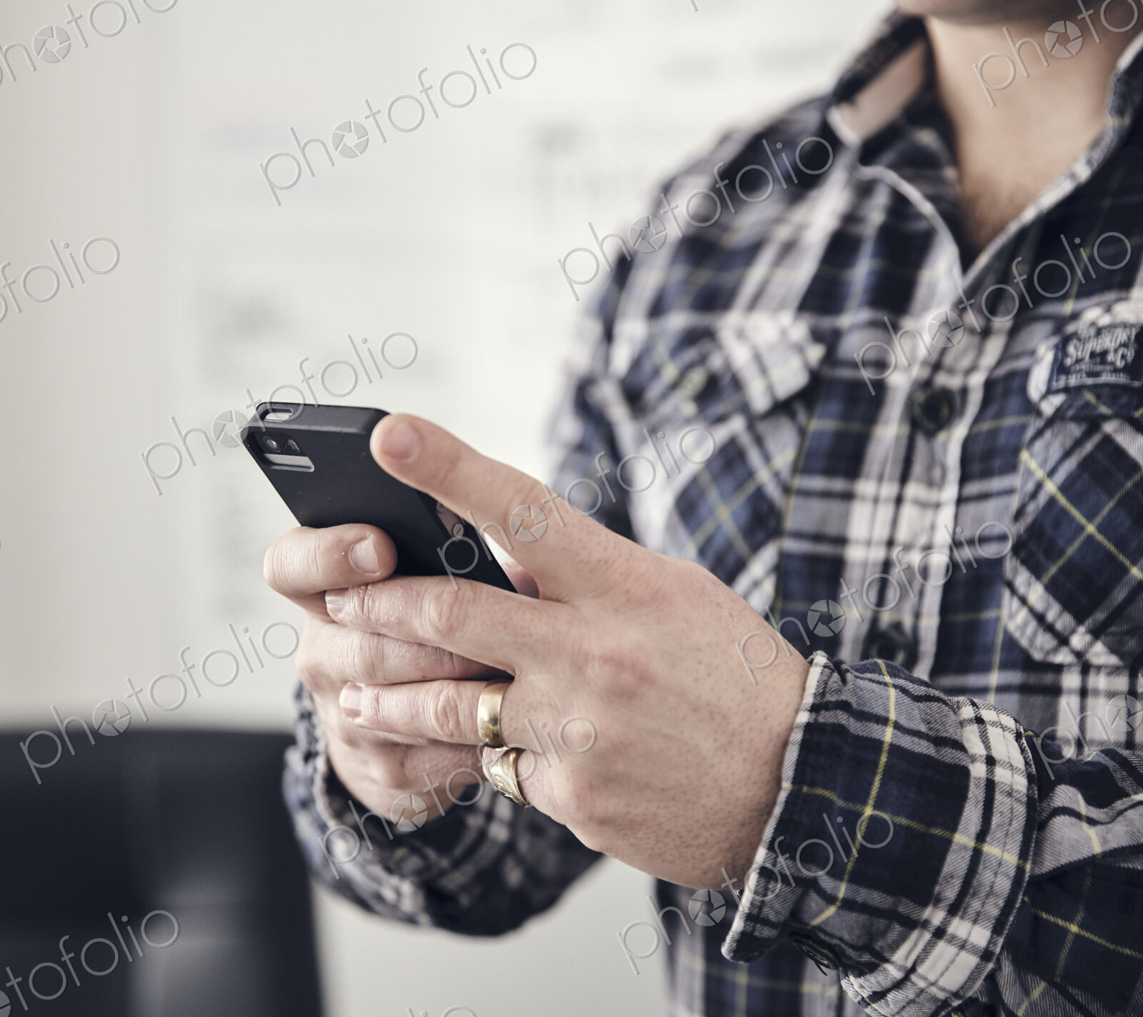 Close up of man’s hands using a mobile phone