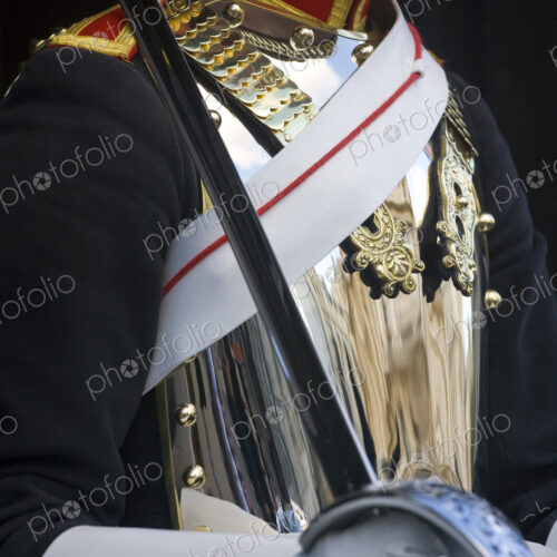 Close up of member of the Blues and Royals, with polished cuirass and sash, holding sword. Close up of member of the Blues and Royals, with polished cuirass and sash, holding sword.