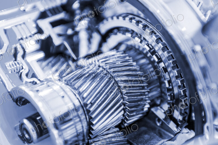 Close up of metal gear inside industrial machinery.