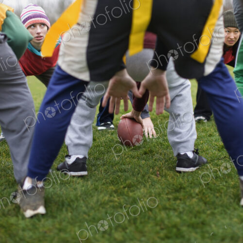 Close up of mixed team members at the line of scrimmage, playing non-contact flag… Close up of mixed team members at the line of scrimmage, playing non-contact flag…