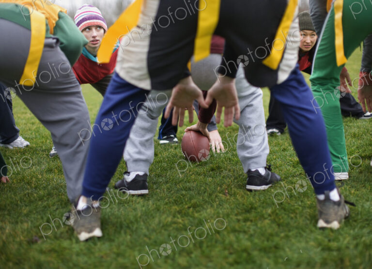 Close up of mixed team members at the line of scrimmage, playing non-contact flag…