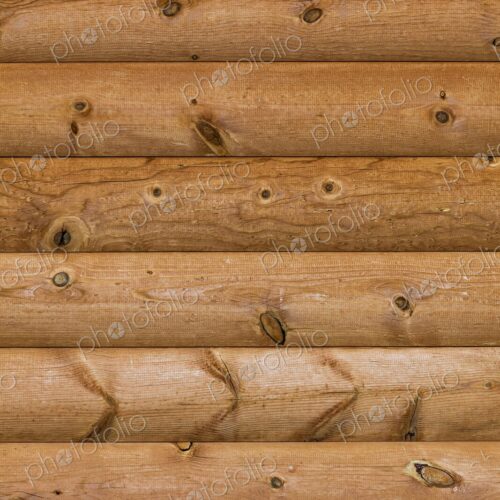 Close-up of natural wood texture and knots in a log cabin wall, highlighting rustic…