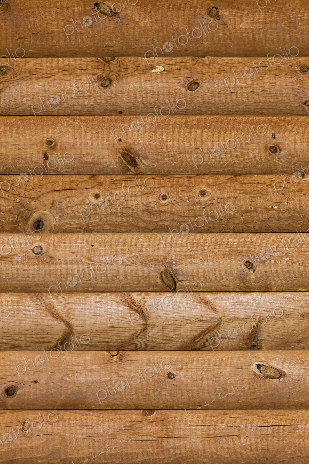 Close-up of natural wood texture and knots in a log cabin wall, highlighting rustic…