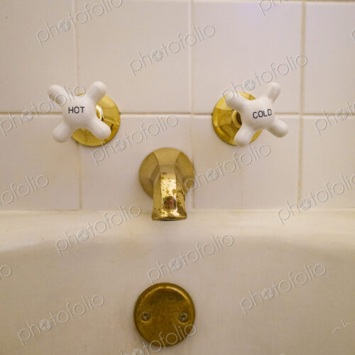 Close-up of old-fashioned bathtub faucet and drain. Close-up of old-fashioned bathtub faucet and drain.